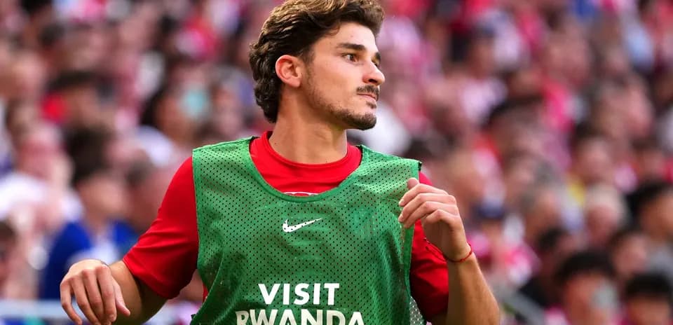 Player in training bib on sidelines during match