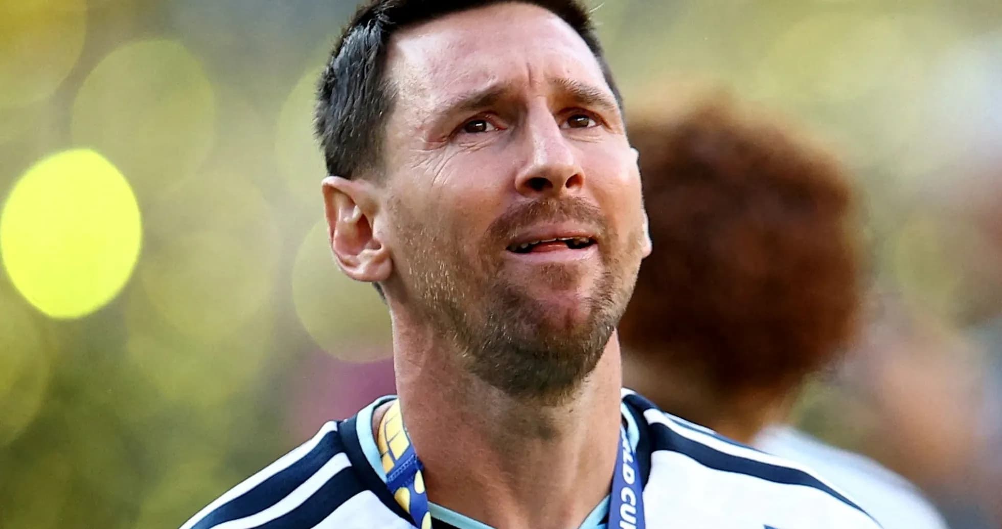 Player with medal celebrating victory in stadium