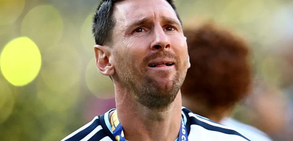 Player with medal celebrating victory in stadium