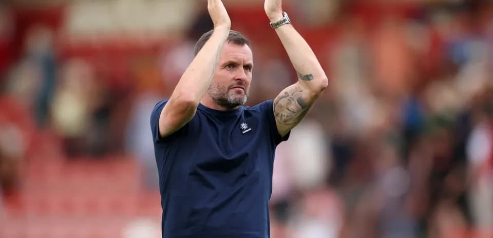 Coach applauding fans after match conclusion