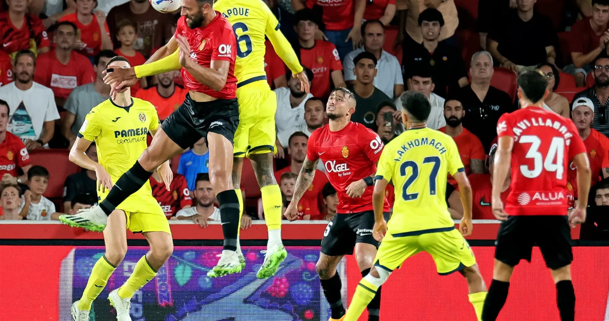 Players contesting a high ball during La Liga match