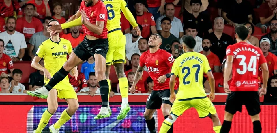 Players contesting a high ball during La Liga match