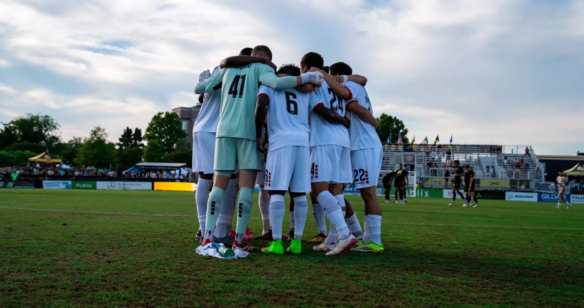 Players huddling before the match