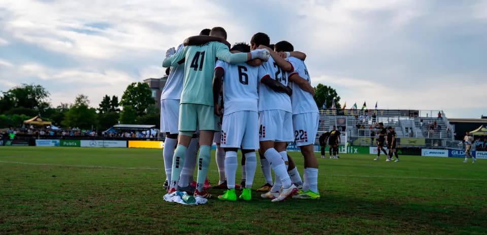 Players huddling before the match