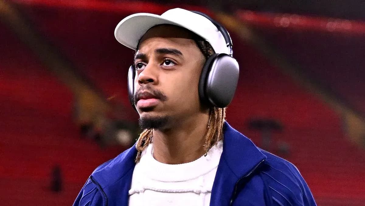 Player wearing headphones walking on stadium field