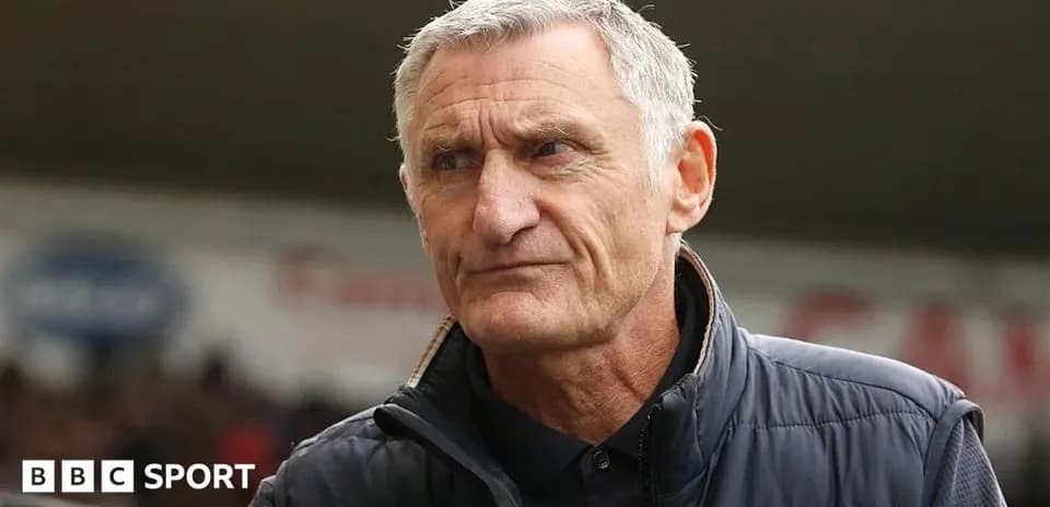 Man in a jacket at a sports venue