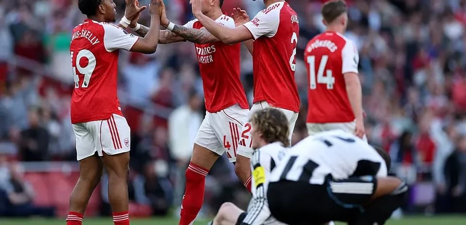 Arsenal players celebrating a goal against Newcastle