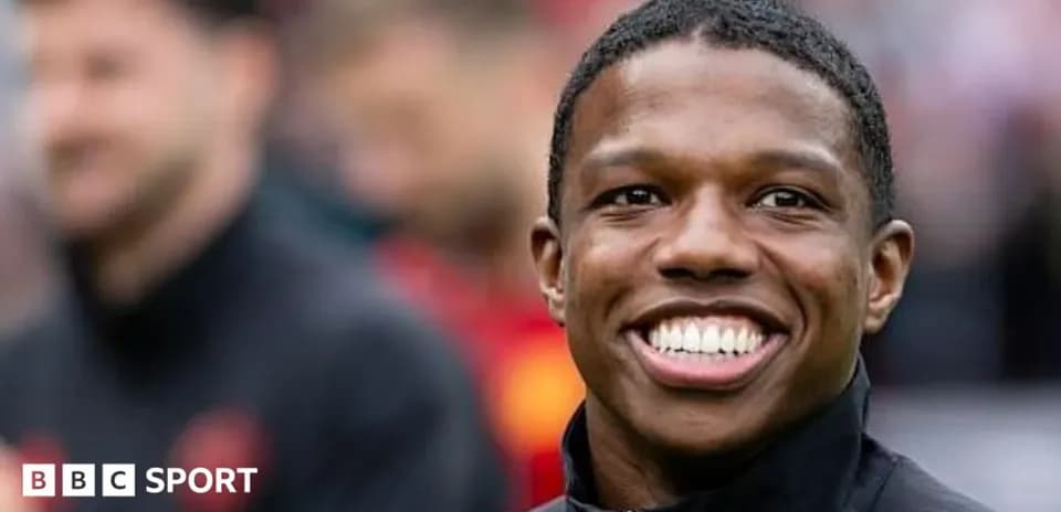 Player smiling on the sidelines before the match
