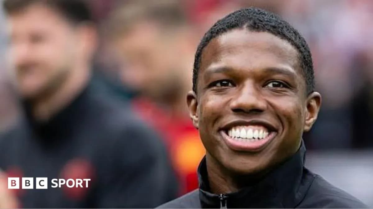 Player smiling on the sidelines before the match