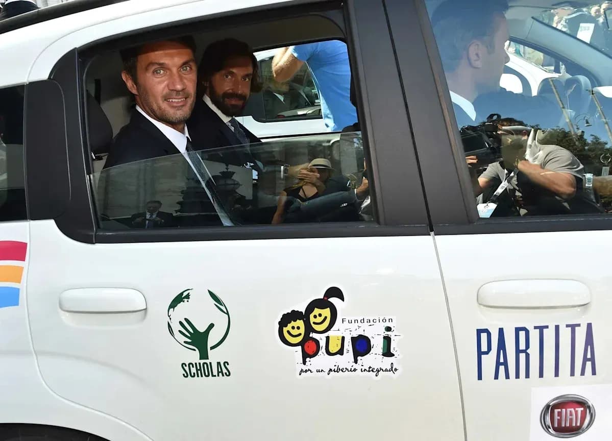 Two men in a car with charity logos