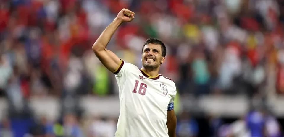 Player celebrating with raised fist in stadium