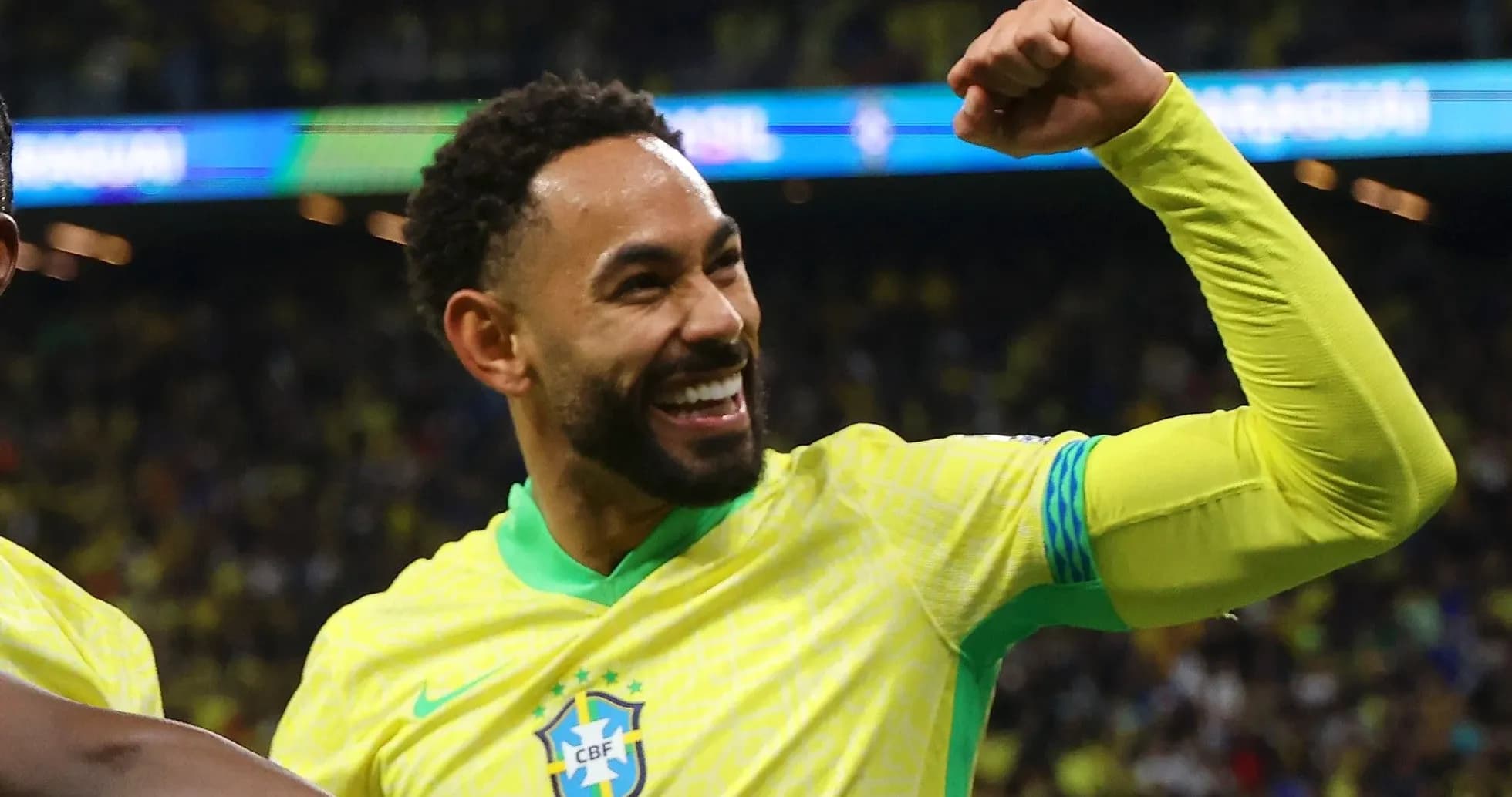 Player celebrating with raised fist in Brazil jersey