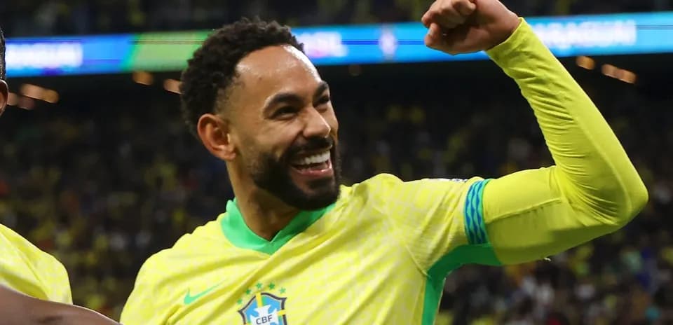 Player celebrating with raised fist in Brazil jersey