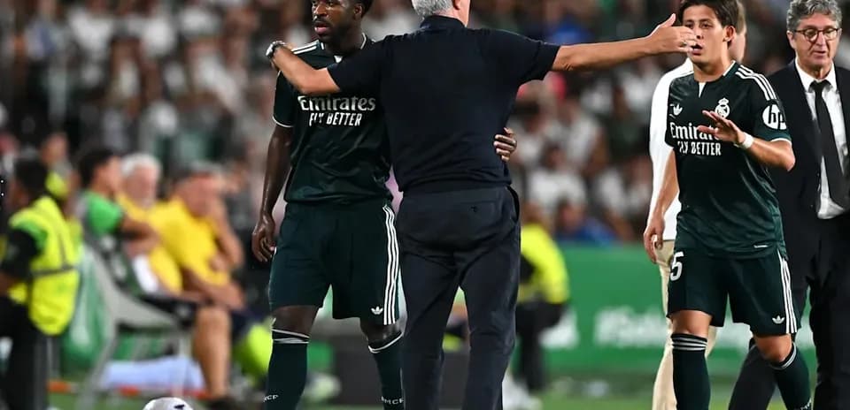 Manager addressing players during match substitution