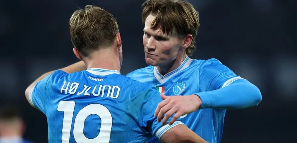 Two Napoli players celebrating together on the pitch