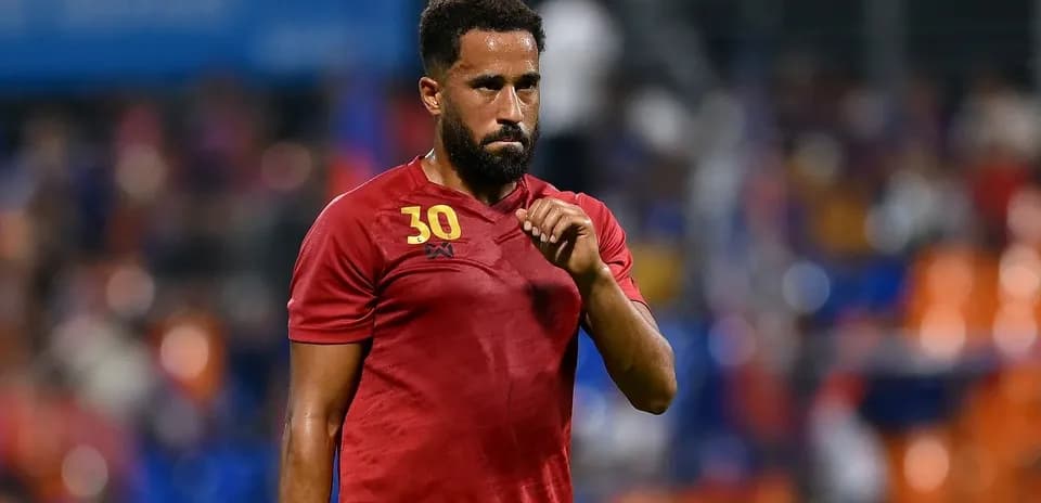 Player wearing red jersey during match action
