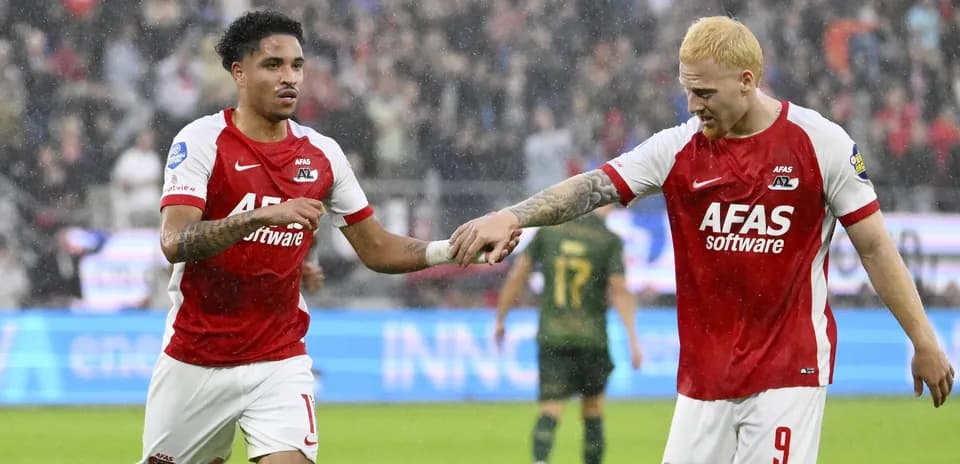 Two AZ Alkmaar players celebrating a goal together