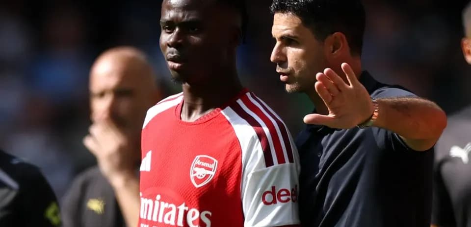 Manager discussing strategy with player during match