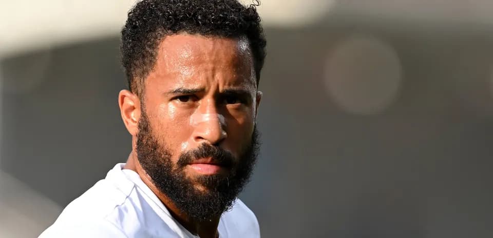 Player with beard looking directly at camera