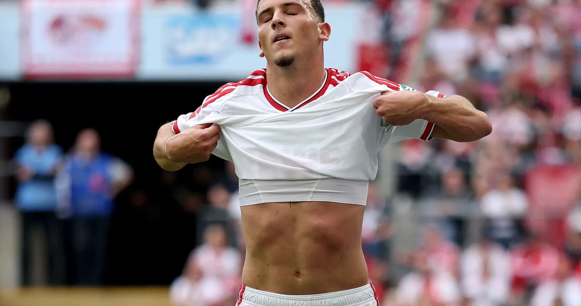 Player lifting shirt during match celebration