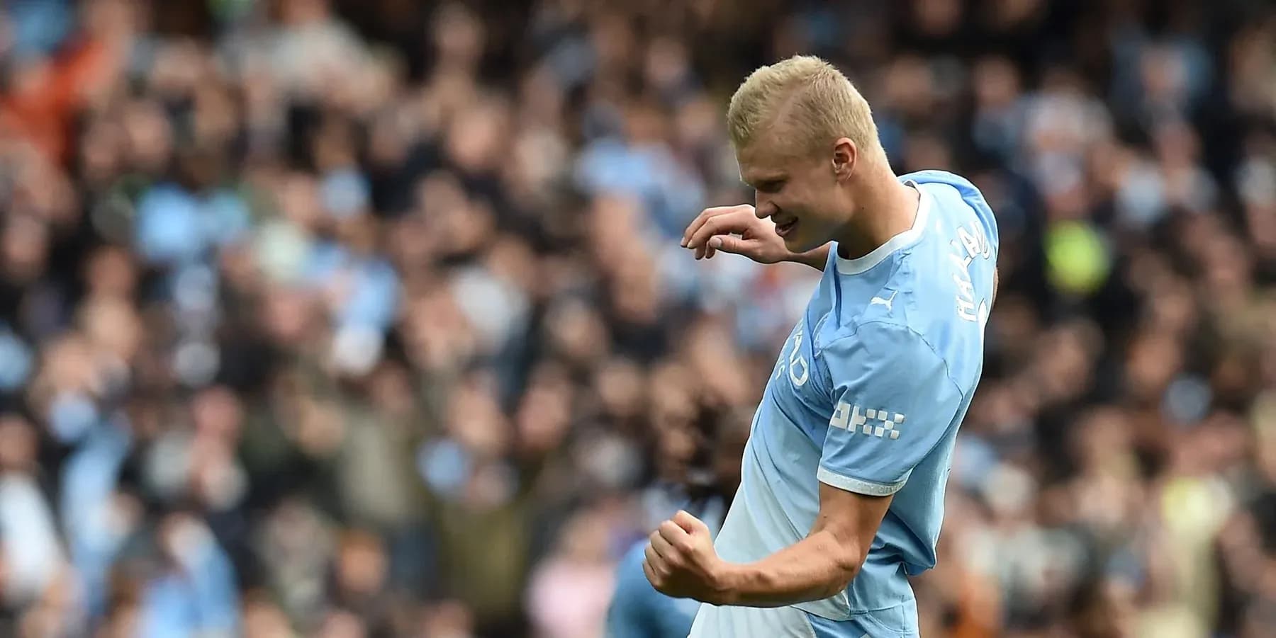 Player celebrating a goal in front of fans