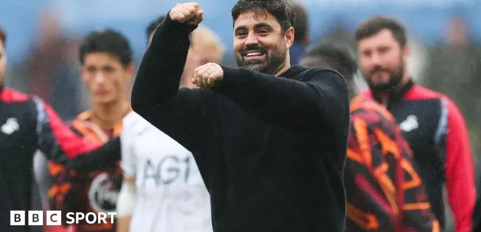 Coach celebrating with team during post-match moment