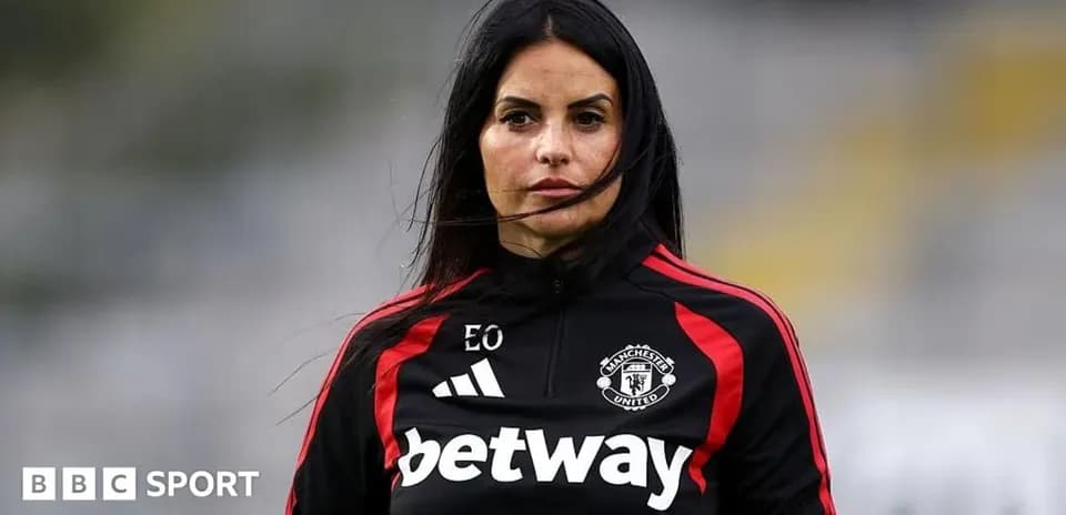 Coach in Manchester United training attire on field