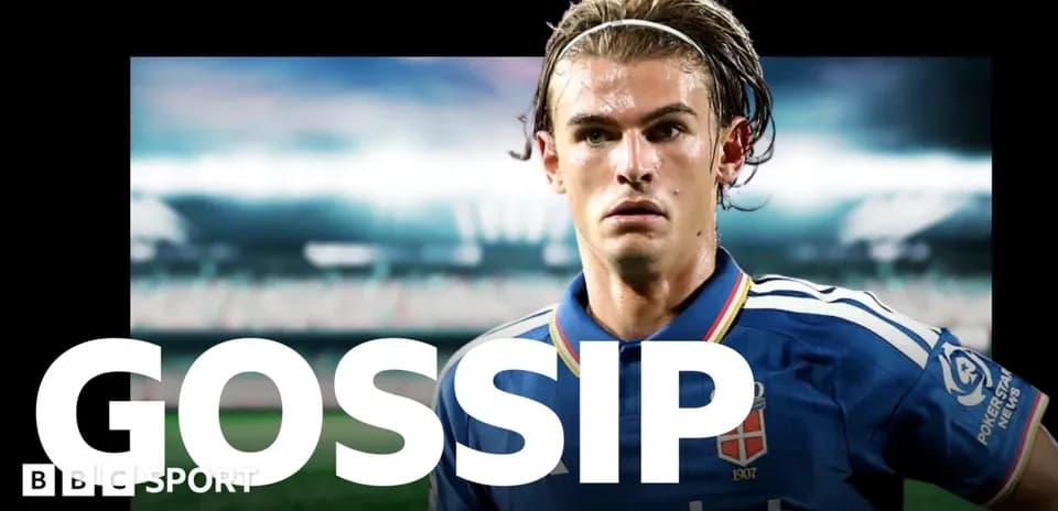 Football player in blue kit with stadium background