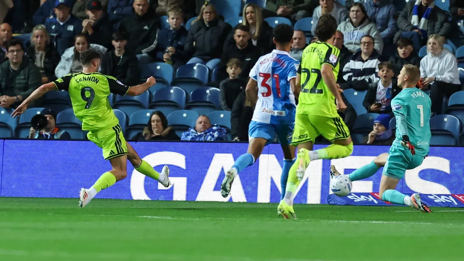 Player shooting on goal while goalkeeper prepares to save