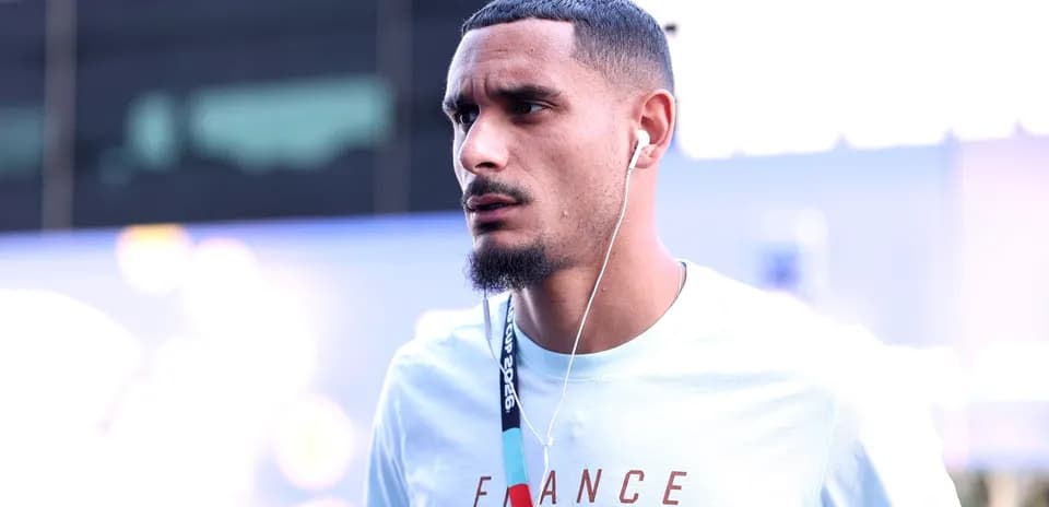 Player wearing headphones arriving at venue