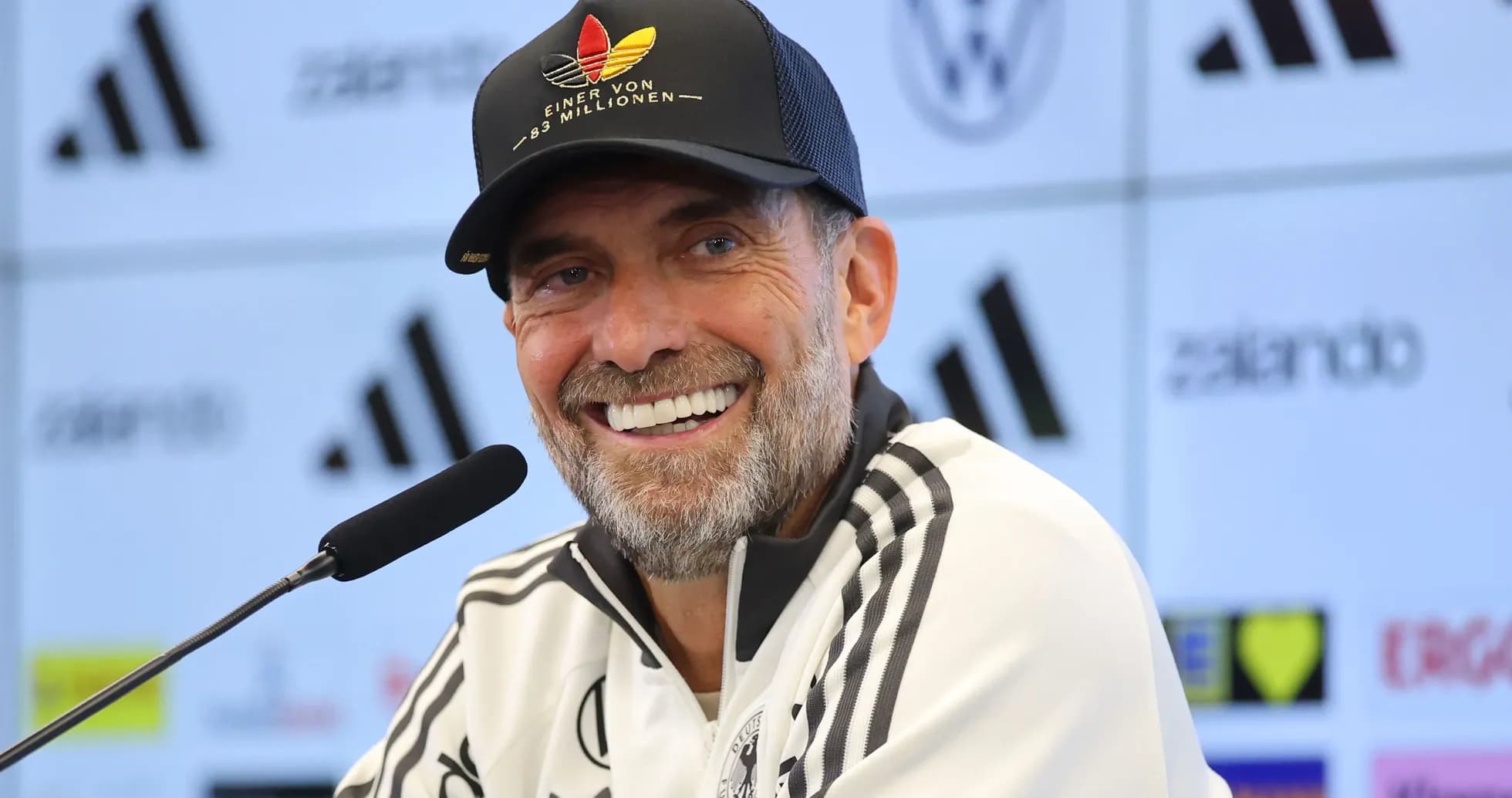 Manager speaking at press conference with microphone
