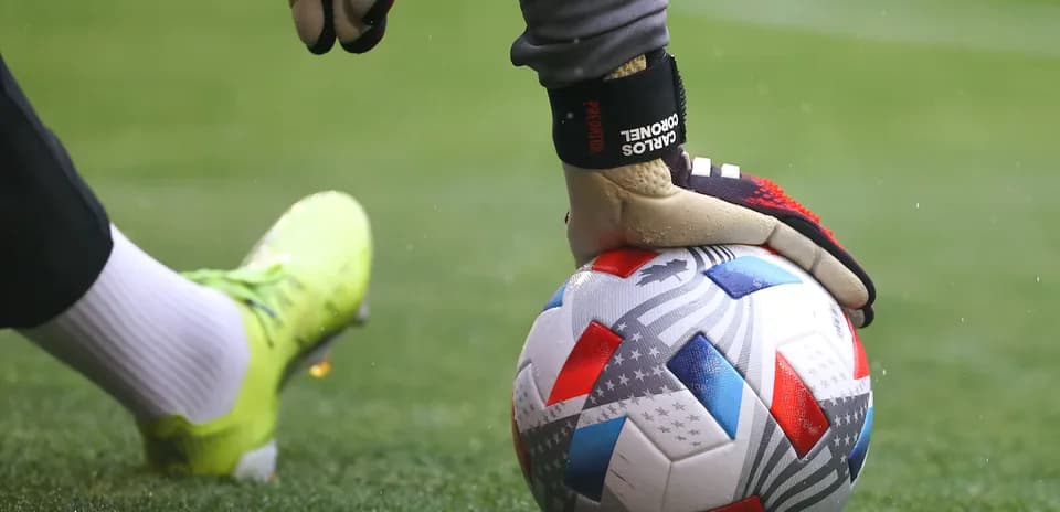 Goalkeeper placing ball on the pitch before kick
