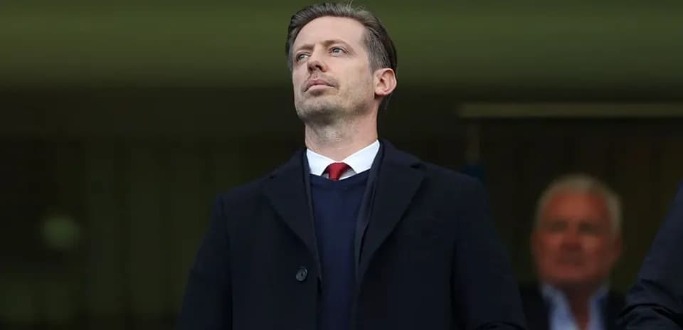 Man in suit observing from the stands