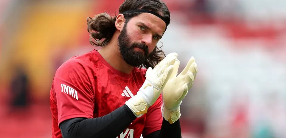 Goalkeeper clapping with gloves during warm-up