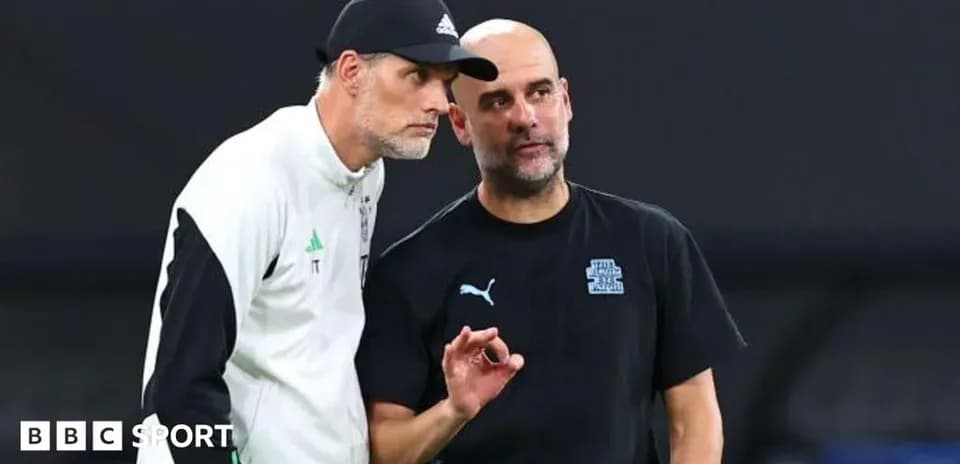 Two football managers discussing strategy on the pitch