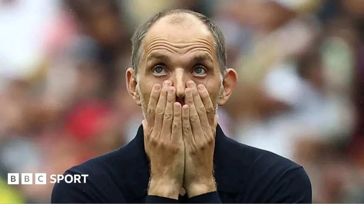 Coach with hands on face during match