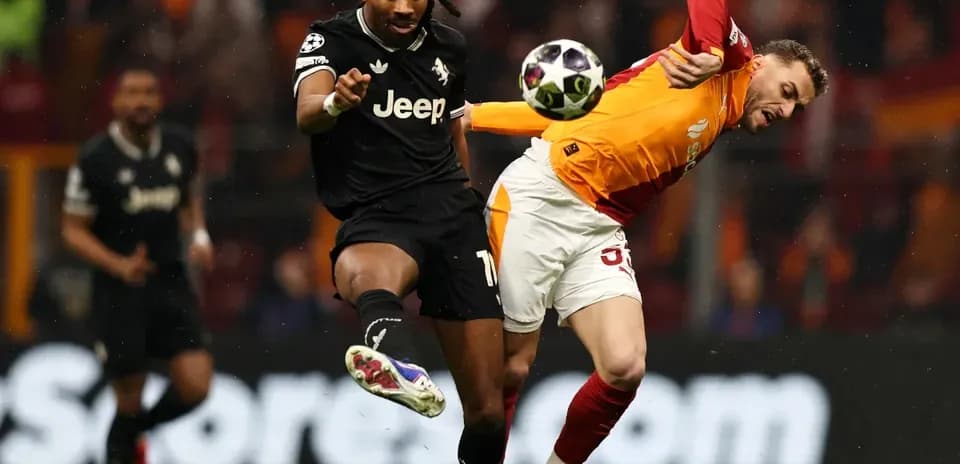 Player kicking ball while opponent falls during match