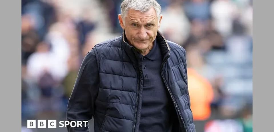 Manager walking on the pitch during match
