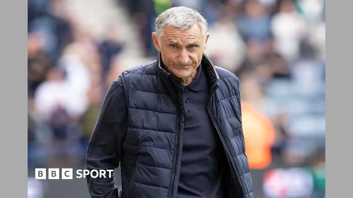 Manager walking on the pitch during match