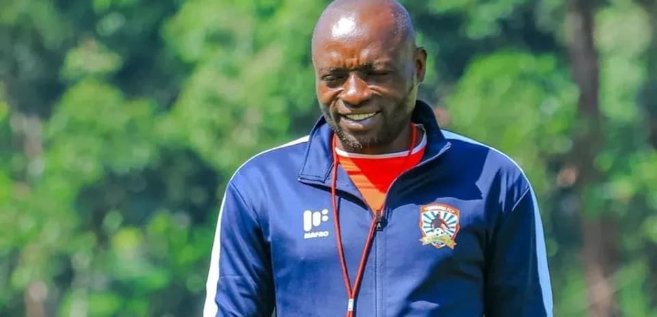 Coach wearing team tracksuit during training session