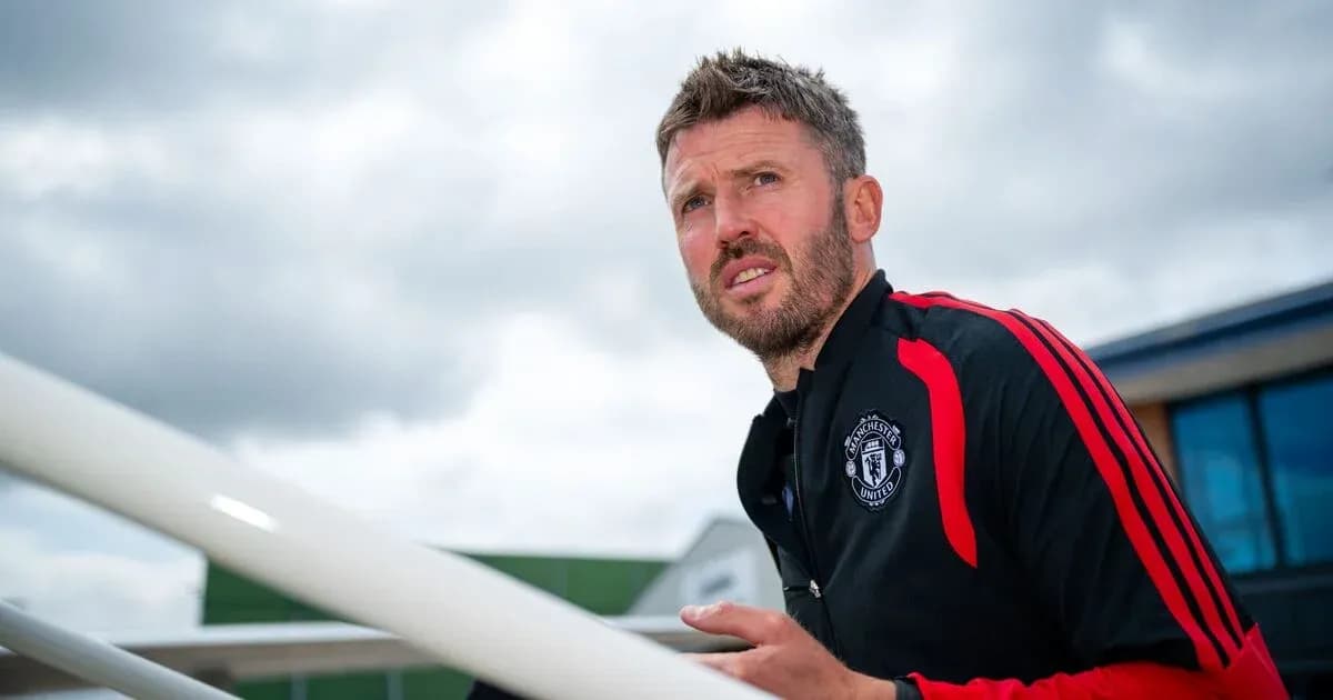Manchester United coach observing training session outdoors