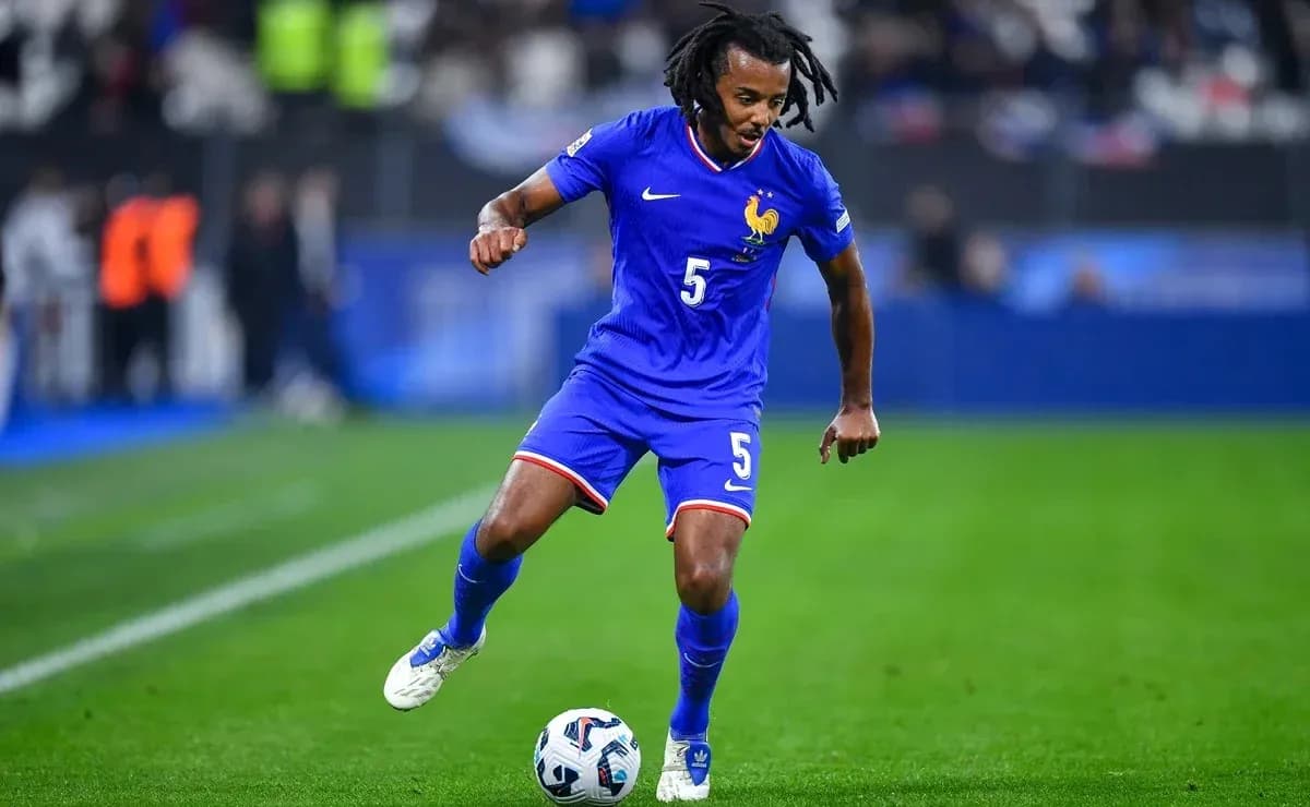 Player in blue kit dribbling ball on field