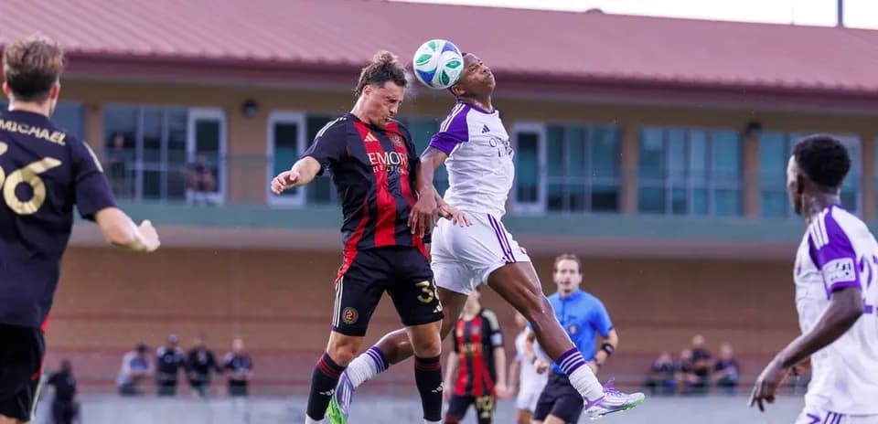 Players competing for the ball in MLS Next Pro match