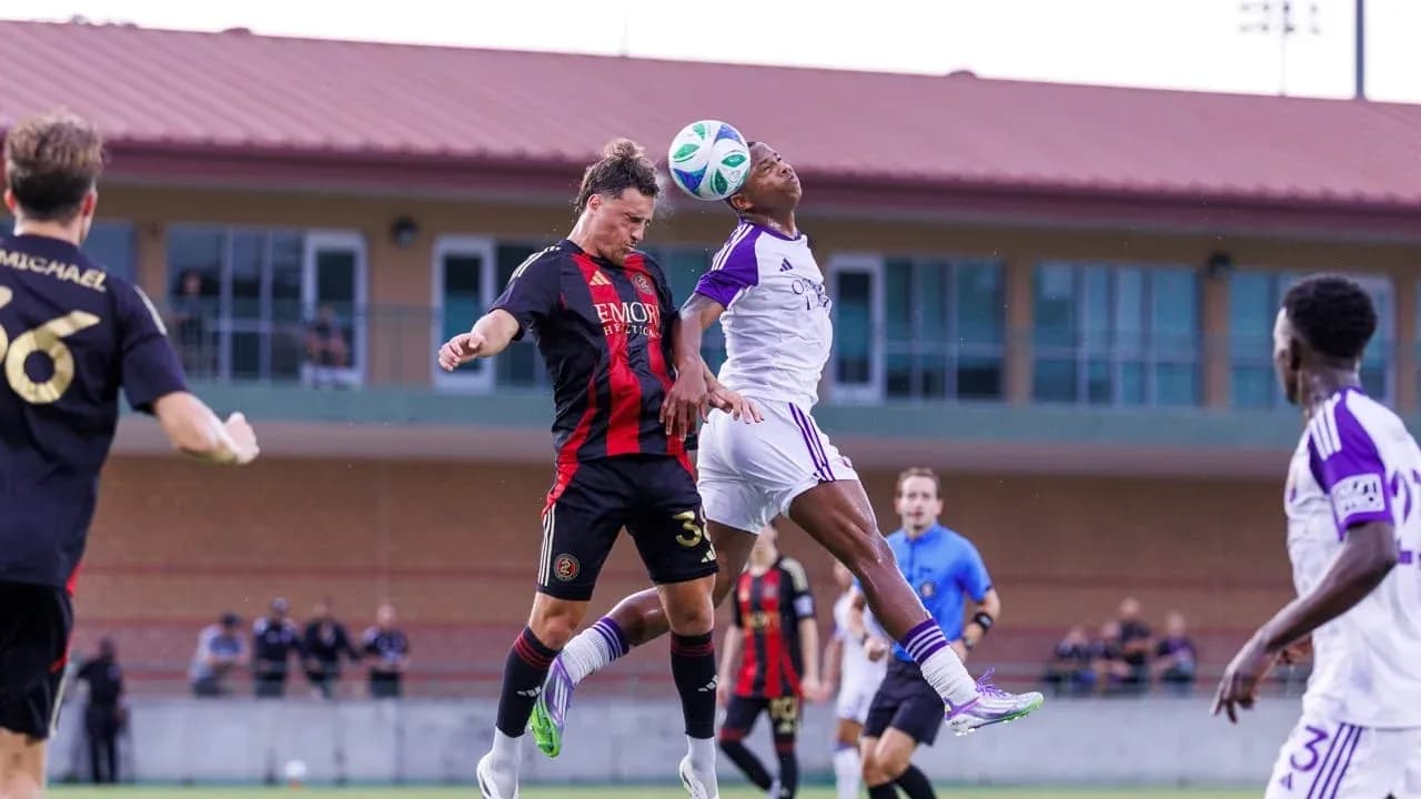 Players competing for the ball in MLS Next Pro match