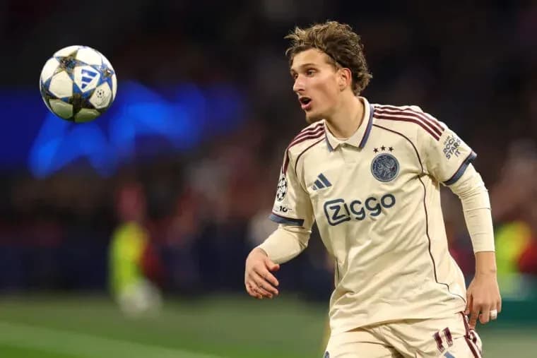 Player in Ajax jersey controlling a football