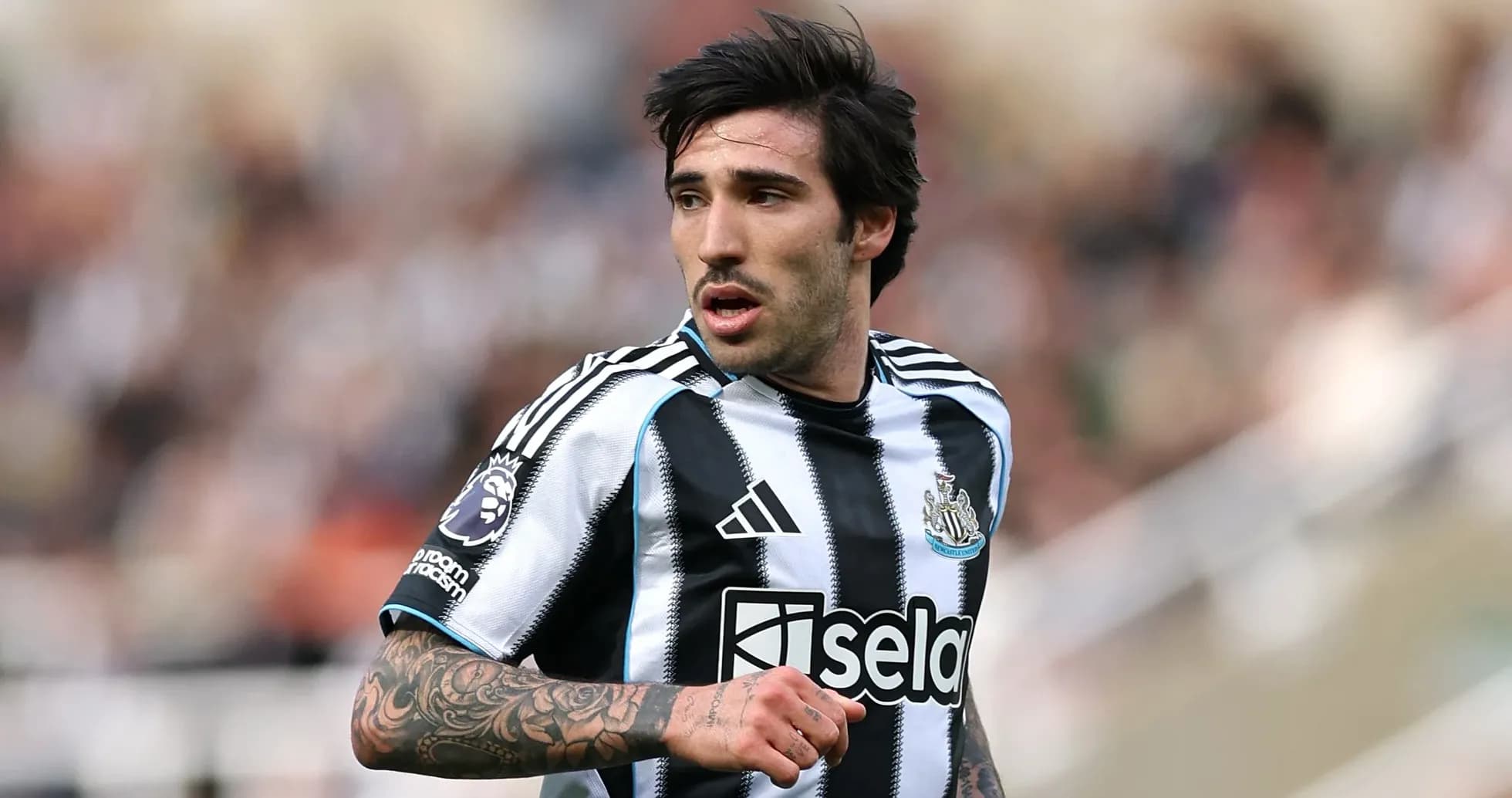 Newcastle player in black and white striped jersey
