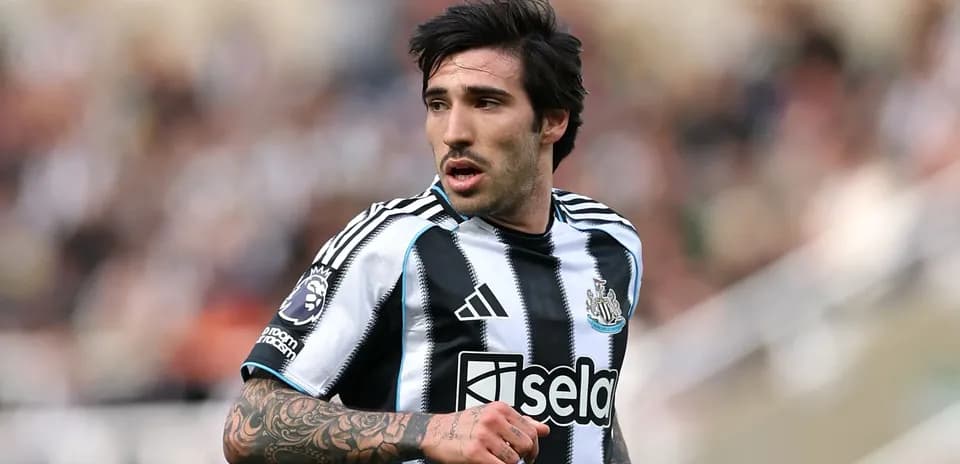 Newcastle player in black and white striped jersey