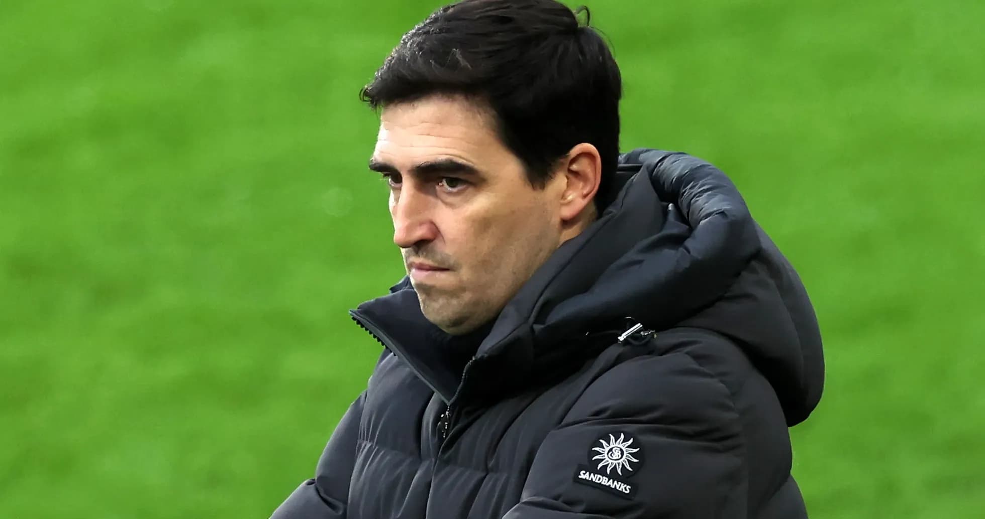 Coach observing the game with focused expression