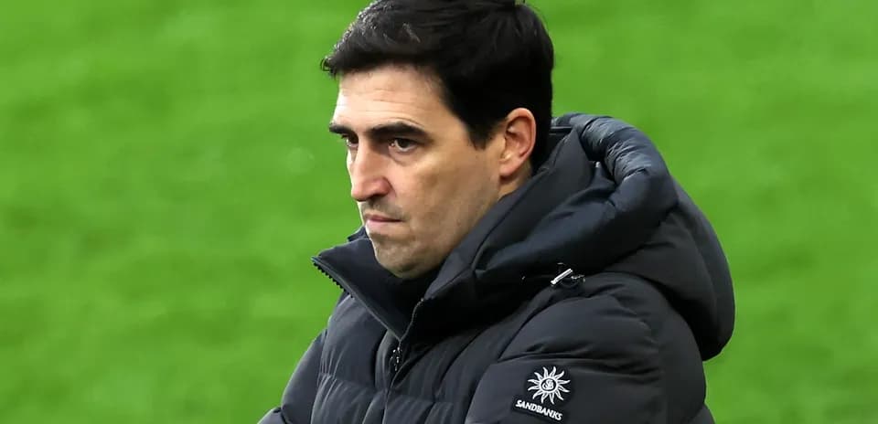 Coach observing the game with focused expression