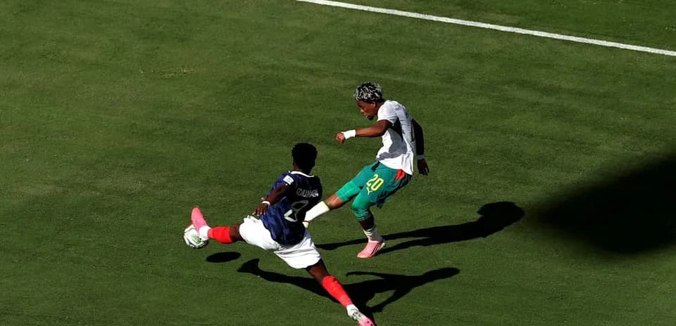Player attempting to dribble past opponent during match